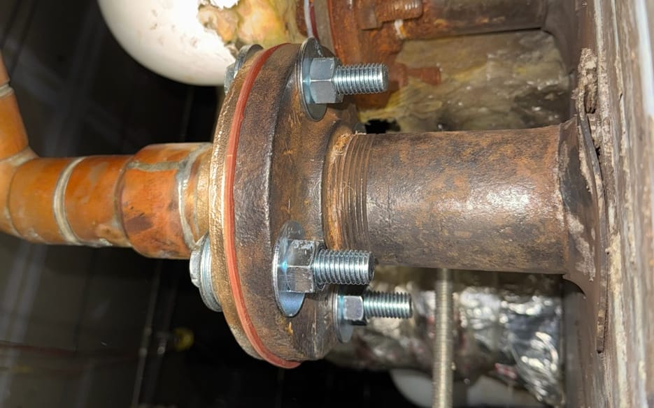 Pipe flange repaired with new bolts and a new gasket