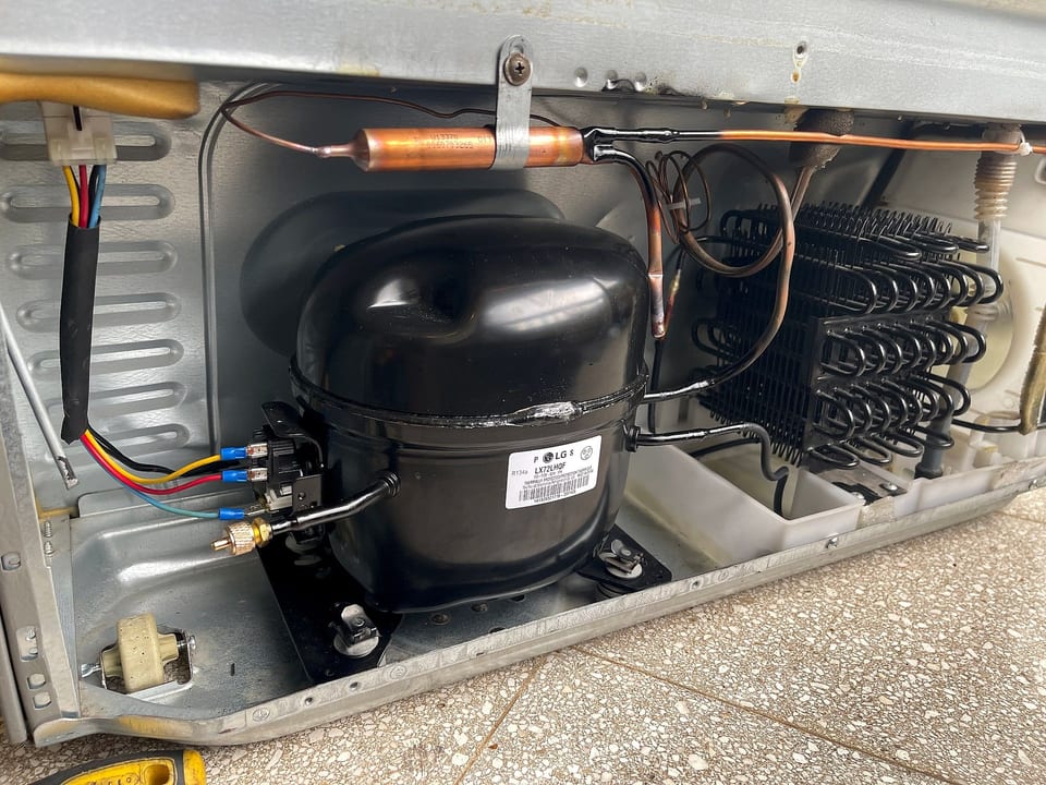Refrigerator compressor and condenser in the machine compartment