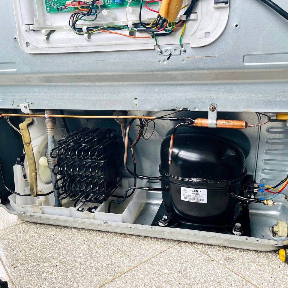 Compressor, condenser coil and control board of a refrigerator under repair