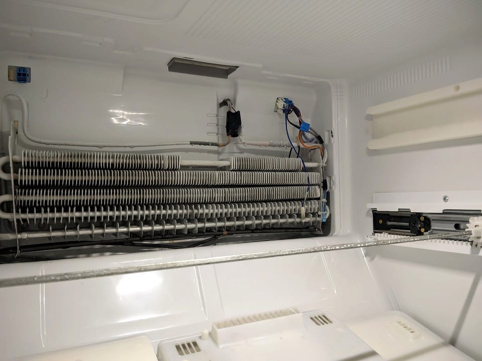 Clean evaporator coil with the freezer panel removed