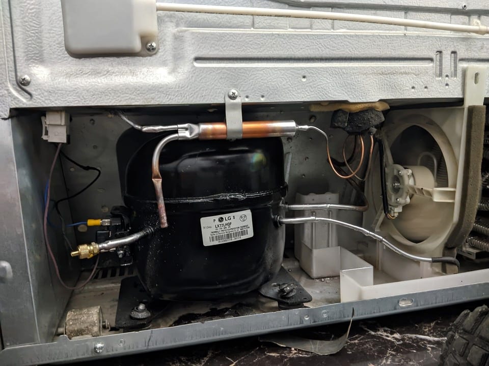 Compressor and sealed-system tubing in a refrigerator's machine compartment